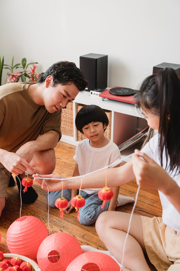 our-story A family sharing quality time assembling red lanterns at home, symbolizing togetherness.